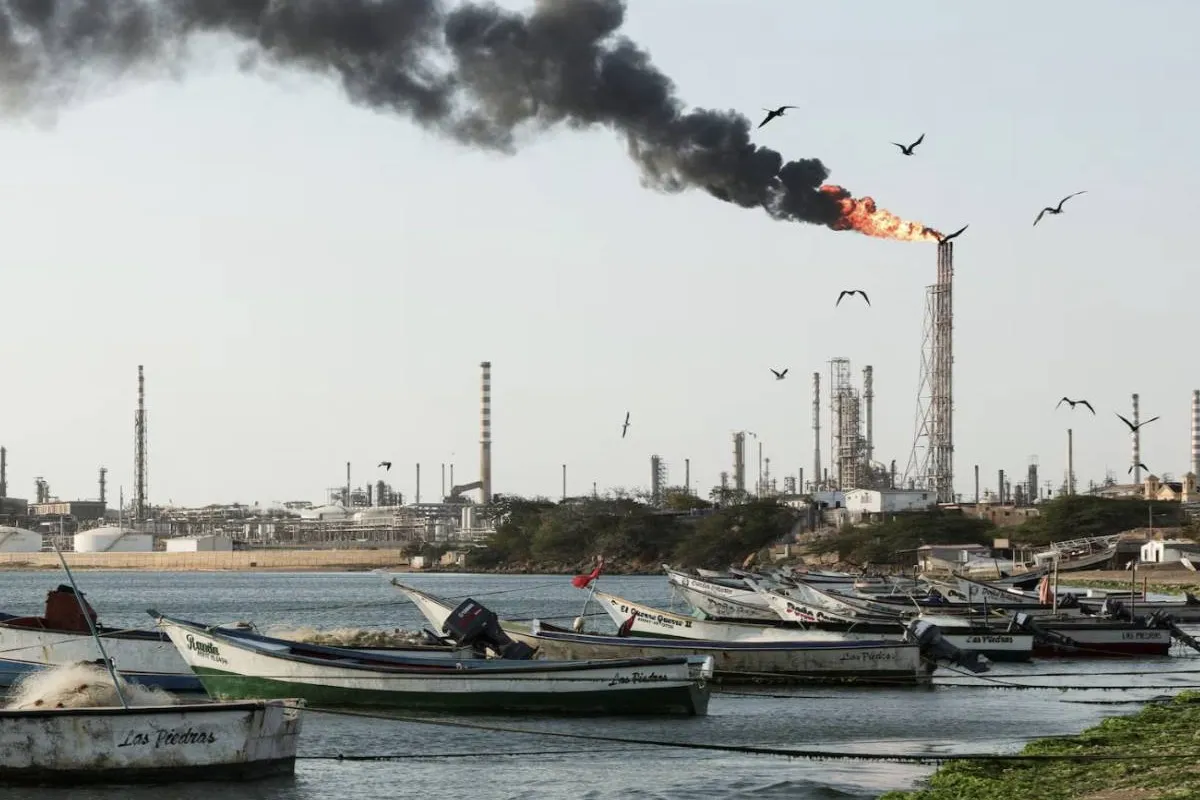 [1/8] Fishing boats are moored on the shoreline near the Cardon refinery, part of the Paraguana Refining Center, as years of underinvestment, equipment failures and shortages have hampered fuel production in Venezuela, in Punta Cardon, Venezuela, May 6, 2