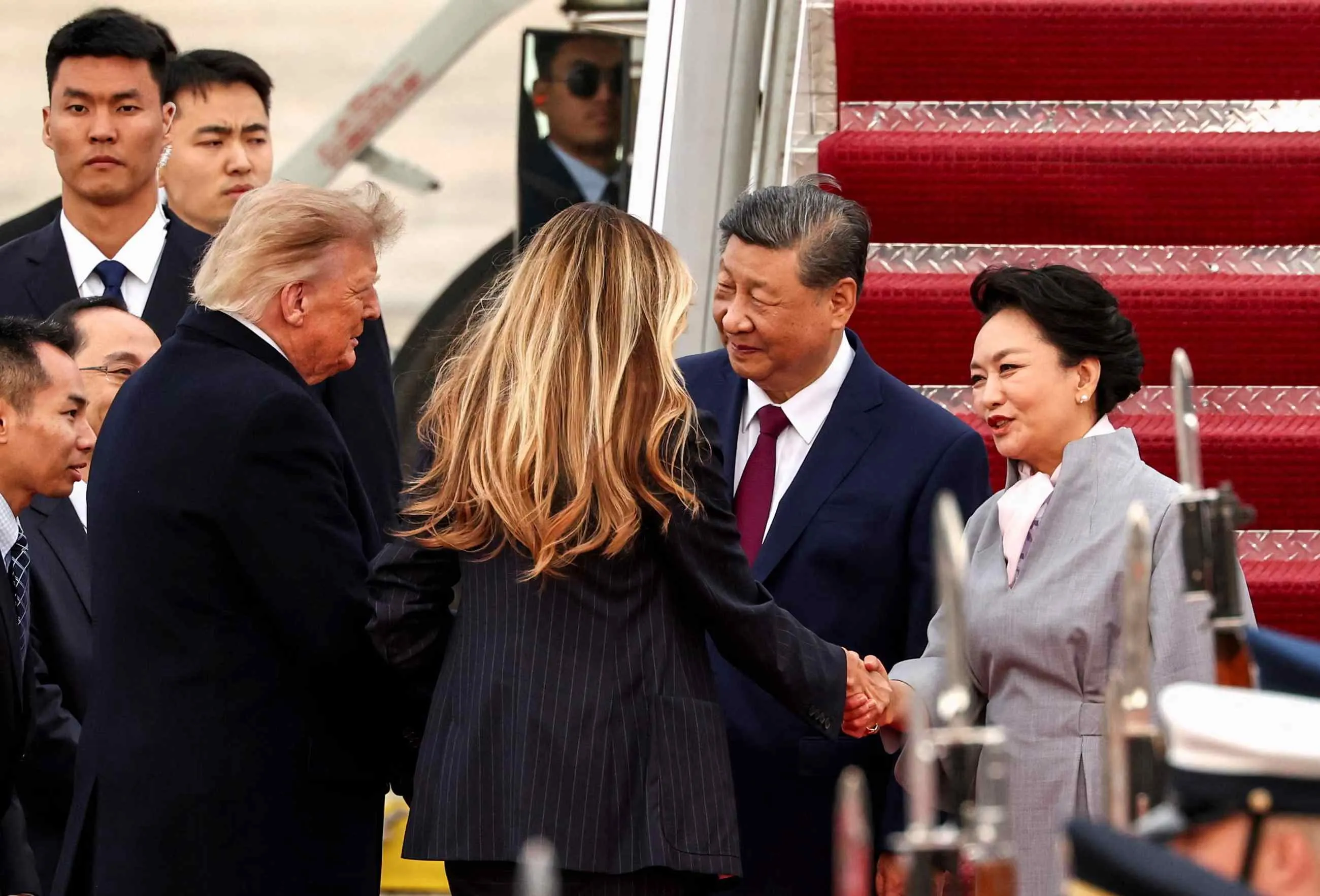 Trump greets Xi Jinping on arrival in rare move as US-China trade truce extended